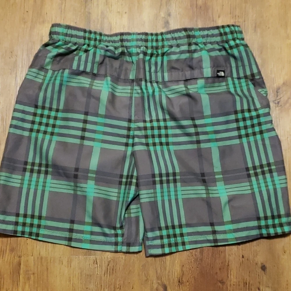 The north face green and gray lined swim trunks